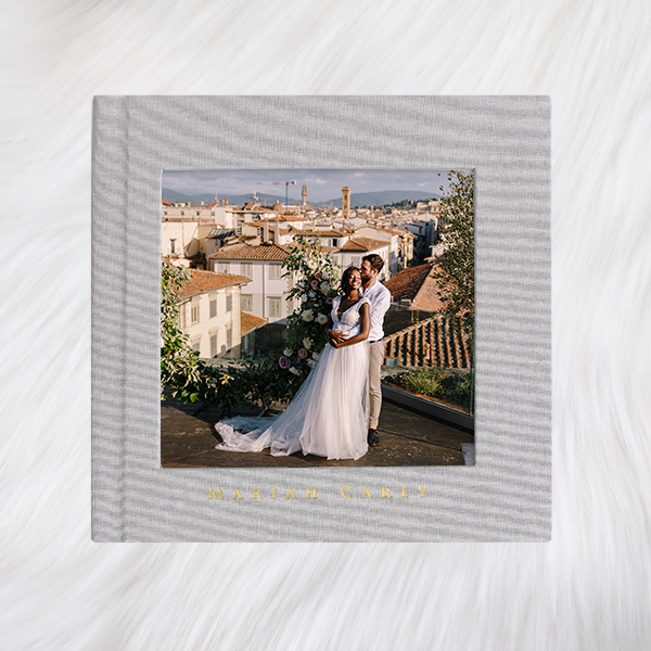 dove grey linen hardcover photo book with inset print couple wedding photography in spain on white carpet