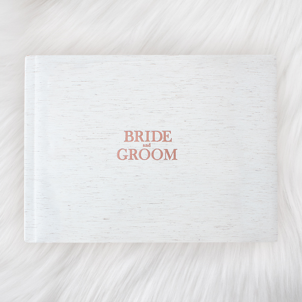 cream light color linen layflat photo book with rose gold foil with text bride and groom as book title