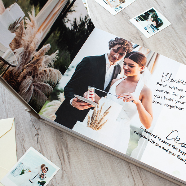 wedding guest book with couple photo on wedding day with invited guest signature on the pages placed on wedding reception table