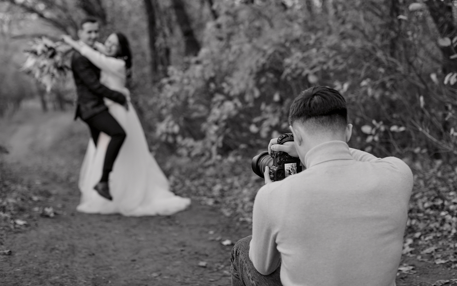 outdoor photography with a couple posing and hugging for wedding photo shot in black and white